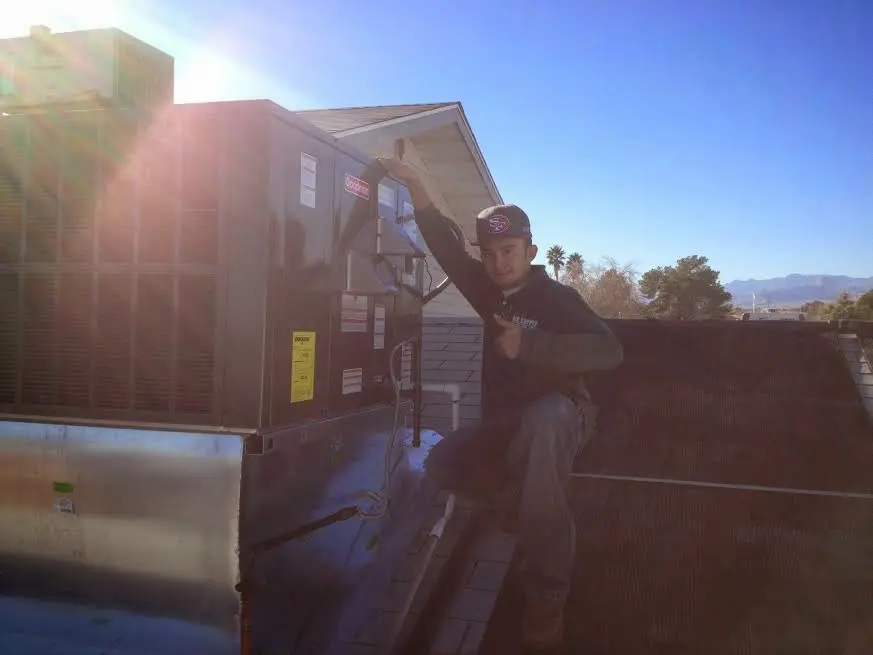 HVAC technician performing HVAC Inspection on a rooftop unit in Oildale